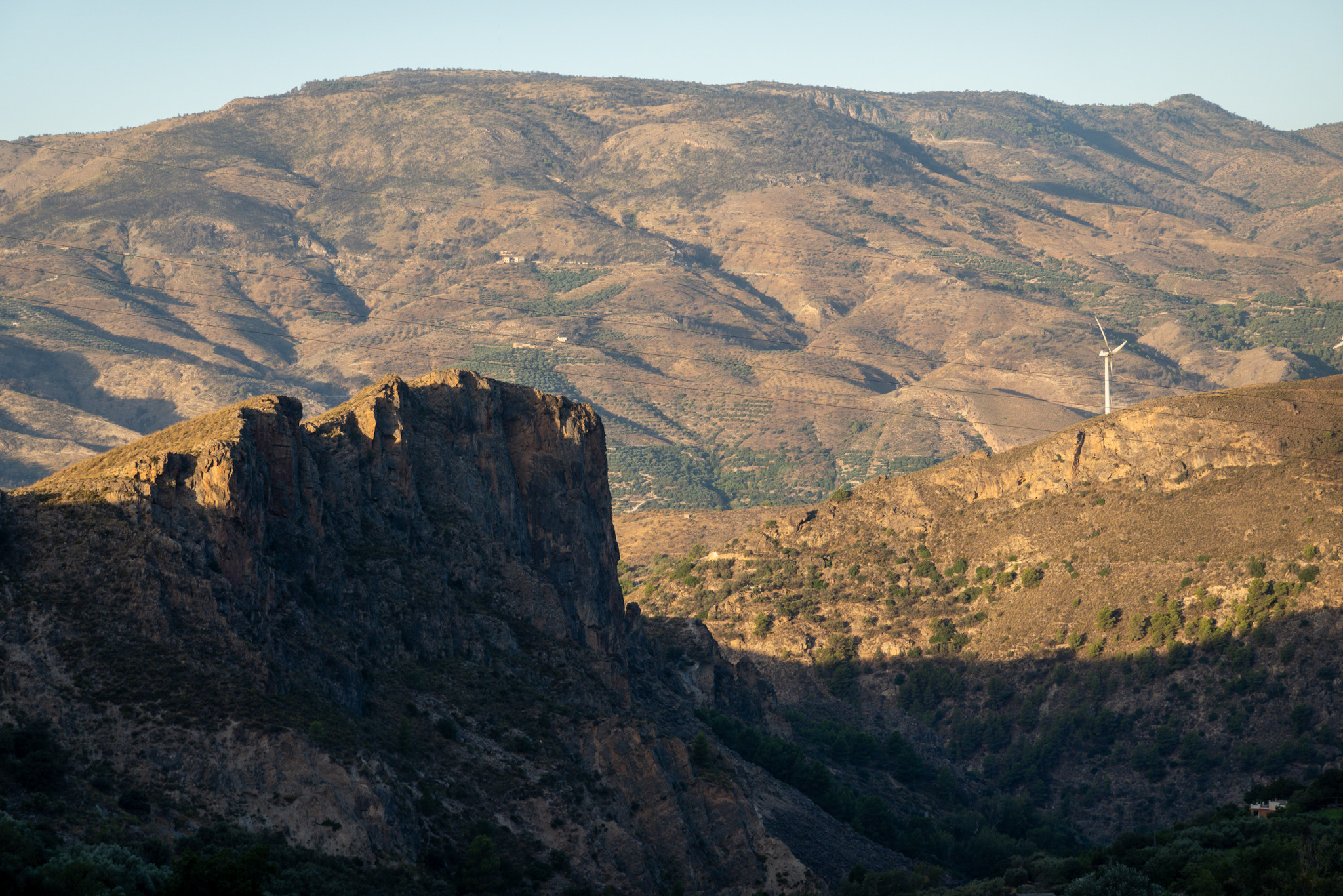The cliffs of Tajos Colerao with early morning sunlight. Beyond the start of the Sierra de Almijara