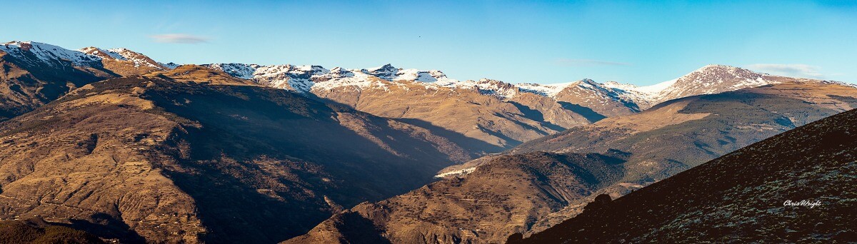 Panorama of the snow capped mountains of Spain's Sierra Nevada shot from the Sierra Lujar about half an hour before sunset. 