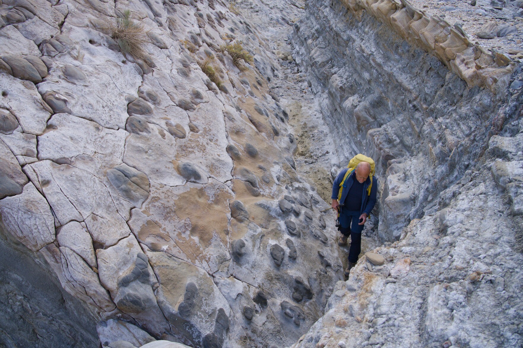 Person hiking through a valley with strange and unusual rock formations. Tabernas, desert badlands, Almeria, Spain