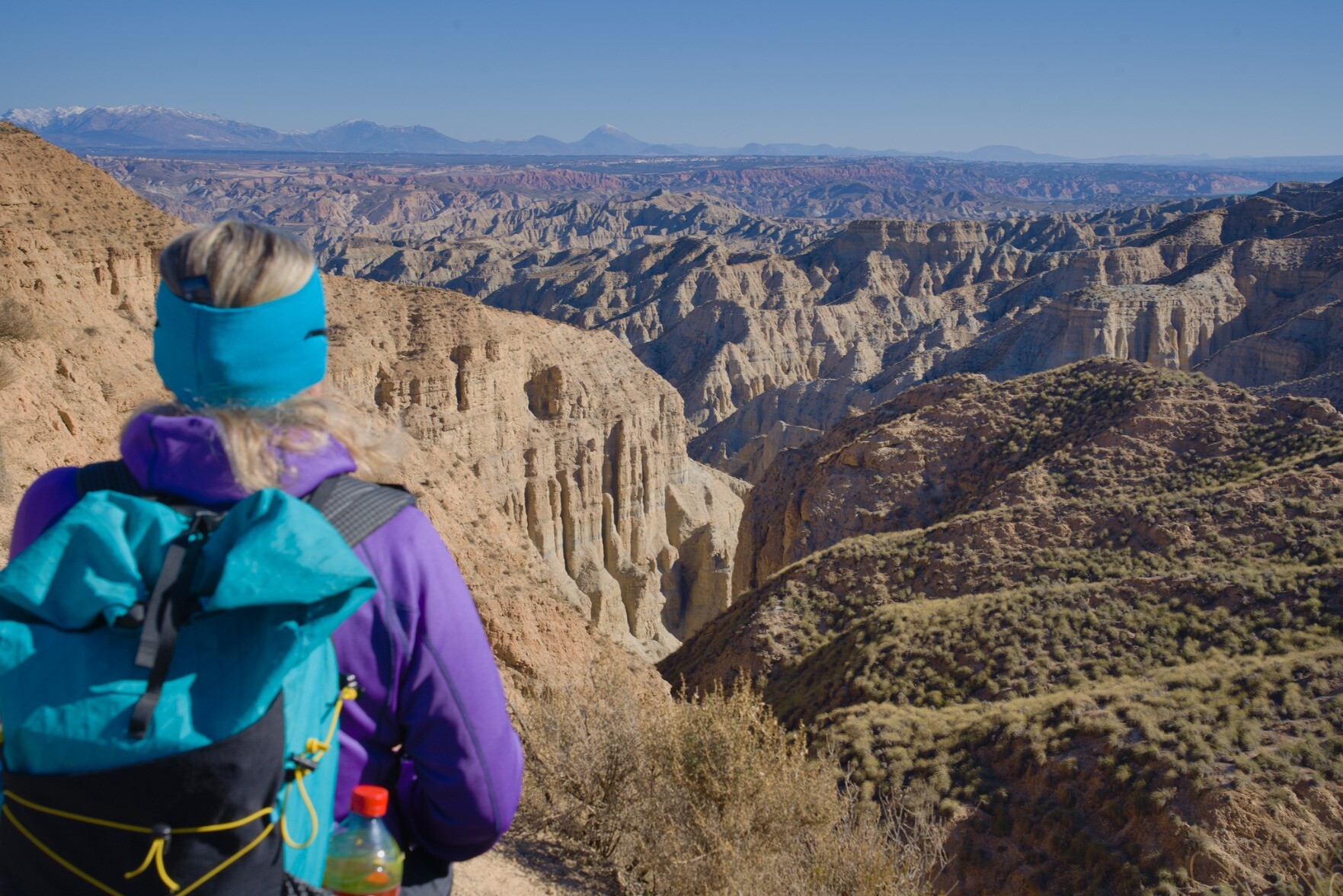 Person stood looking down a twisted deep rock gorge