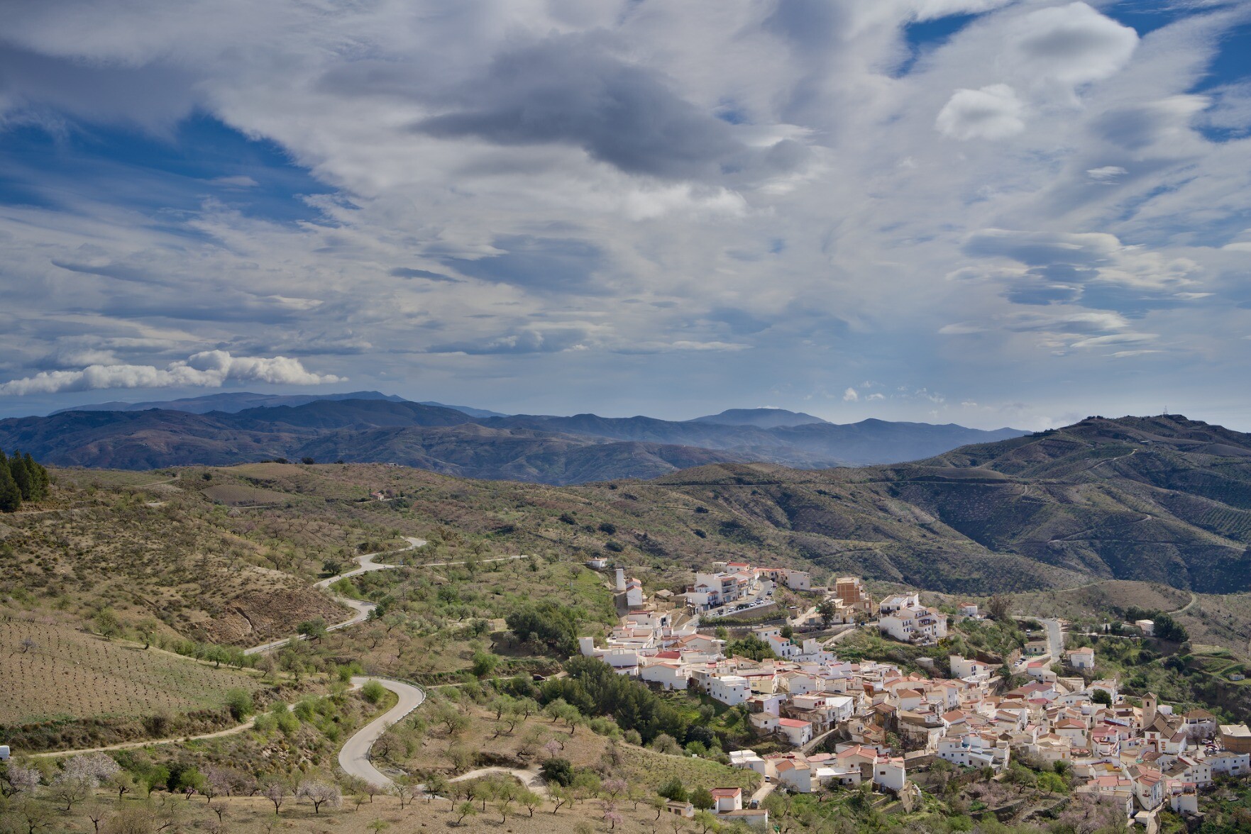 Spanish village of Sorvilán with lenticular clouds above signifying strong winds