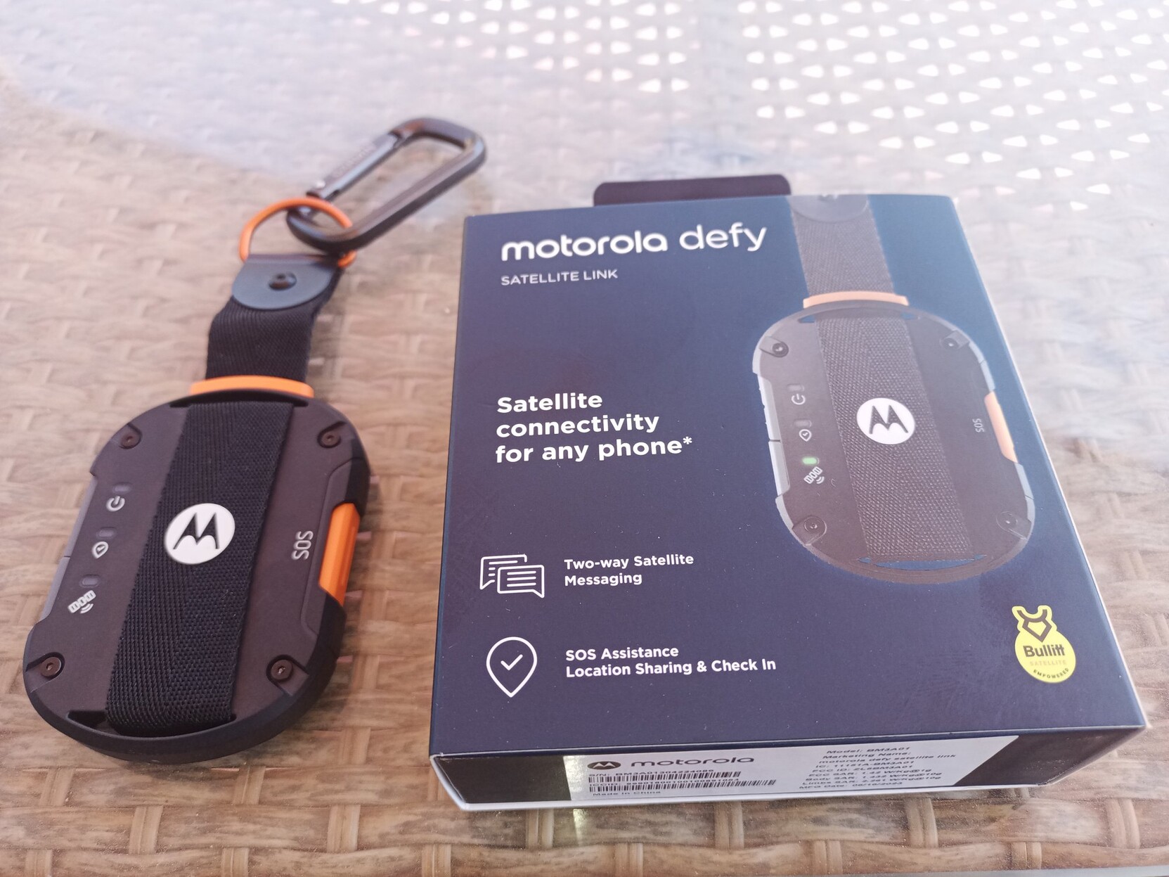 A Motorola Defy Satellite Link unit is to the left and the box it came in, to the right