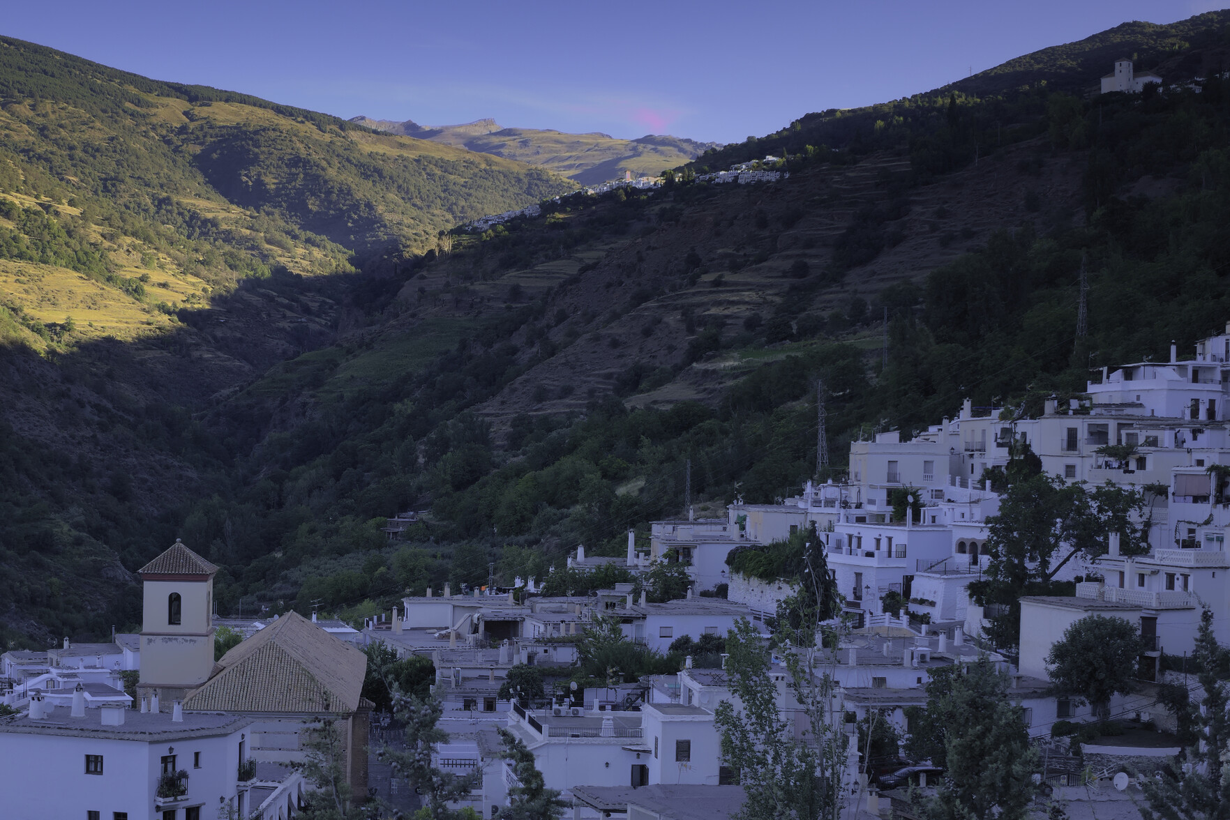 The village of Pampaneira looking towards the Poqueira Gorge with Capileira on the skyline and the mountains of the Sierra Nevada beyond (Veleta 3394m)
