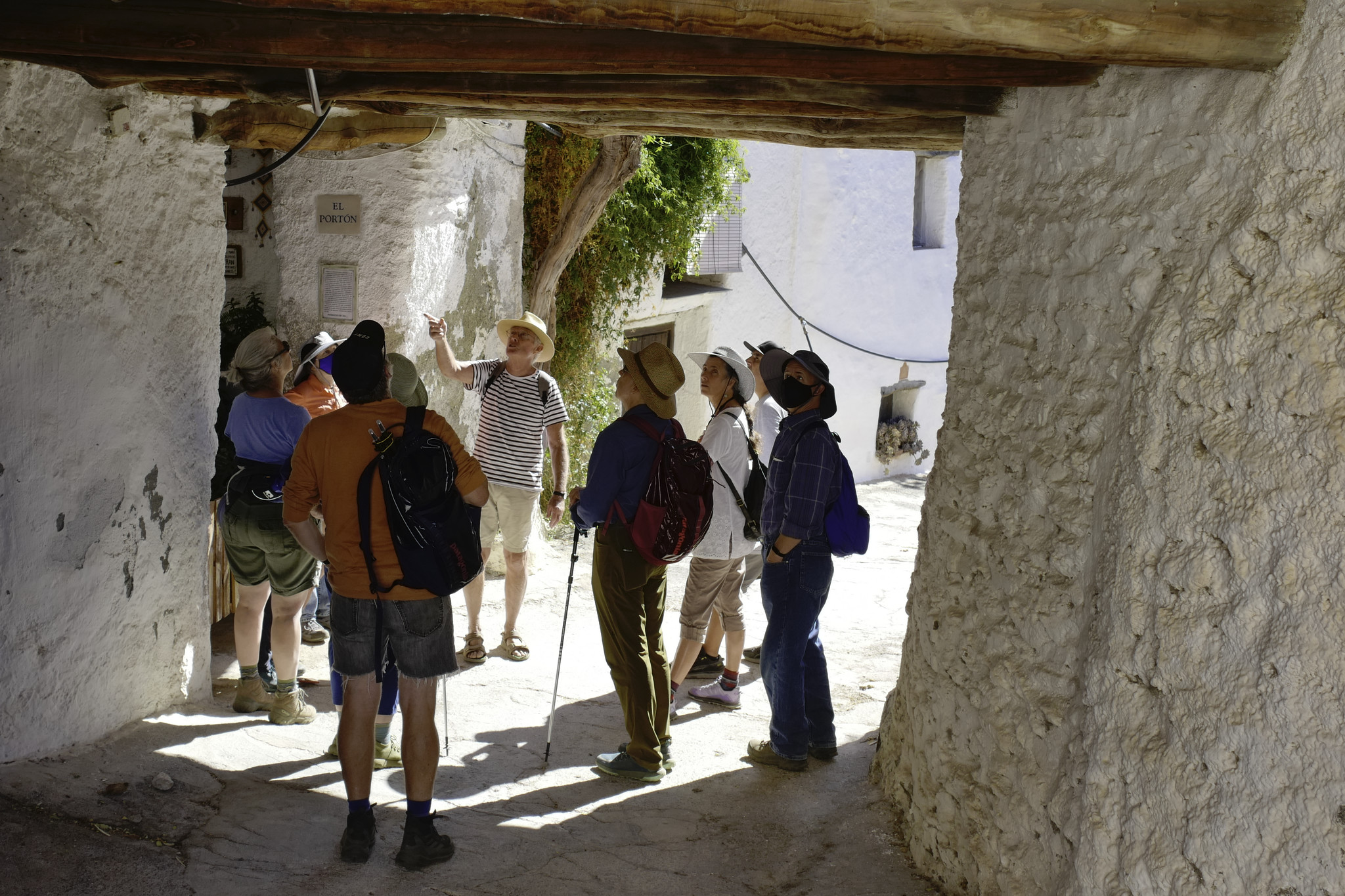 Some people talk beneath some old ancient patios in a traditional spanish village