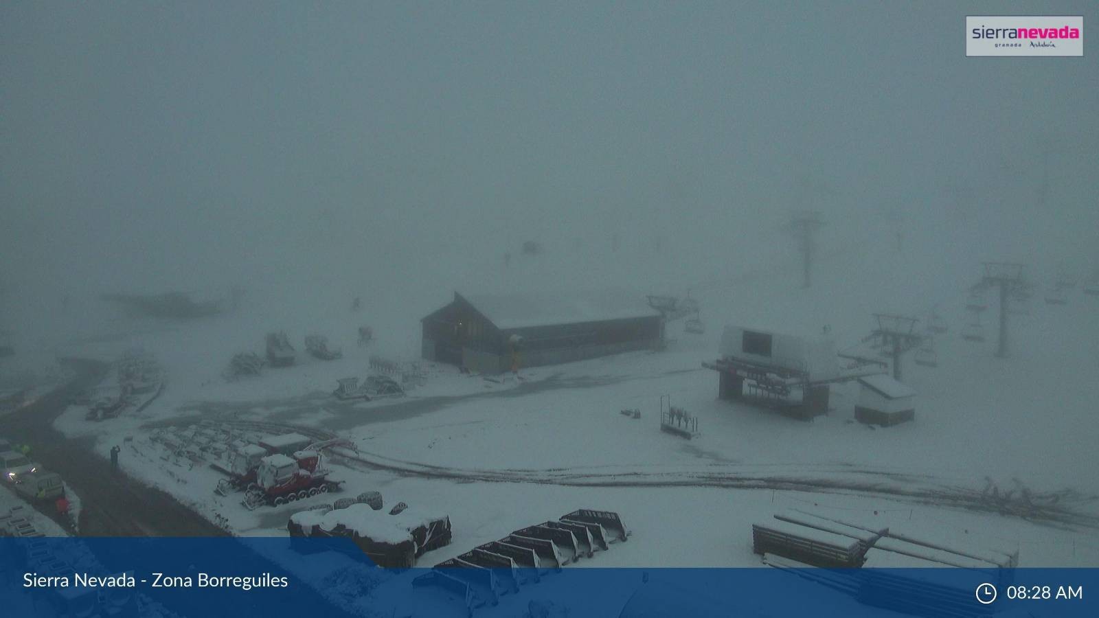 A snow scene which includes ski buildings and equipment