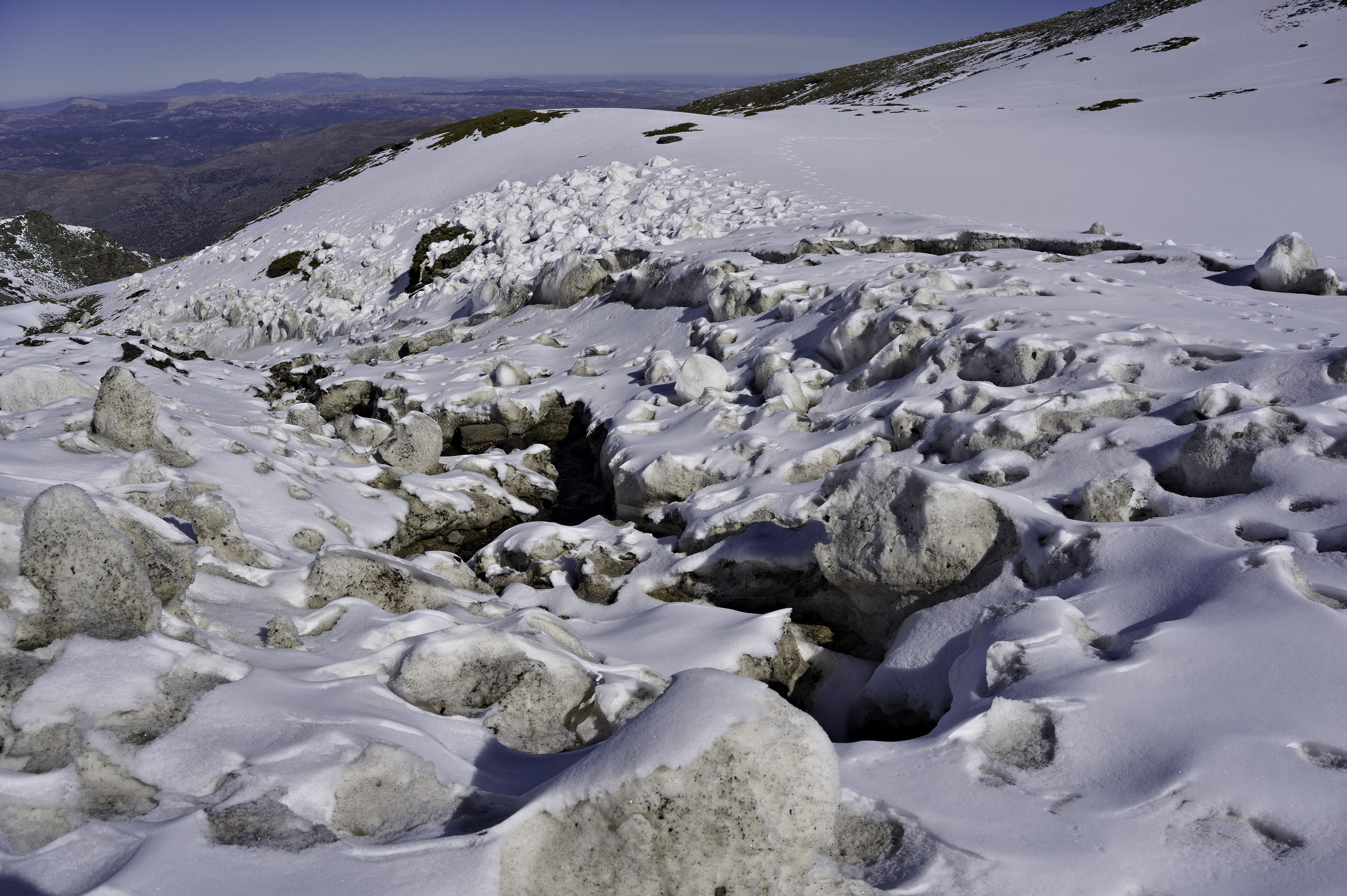 Large blocks of snow/ice have been moved downstream by overflowing streams
