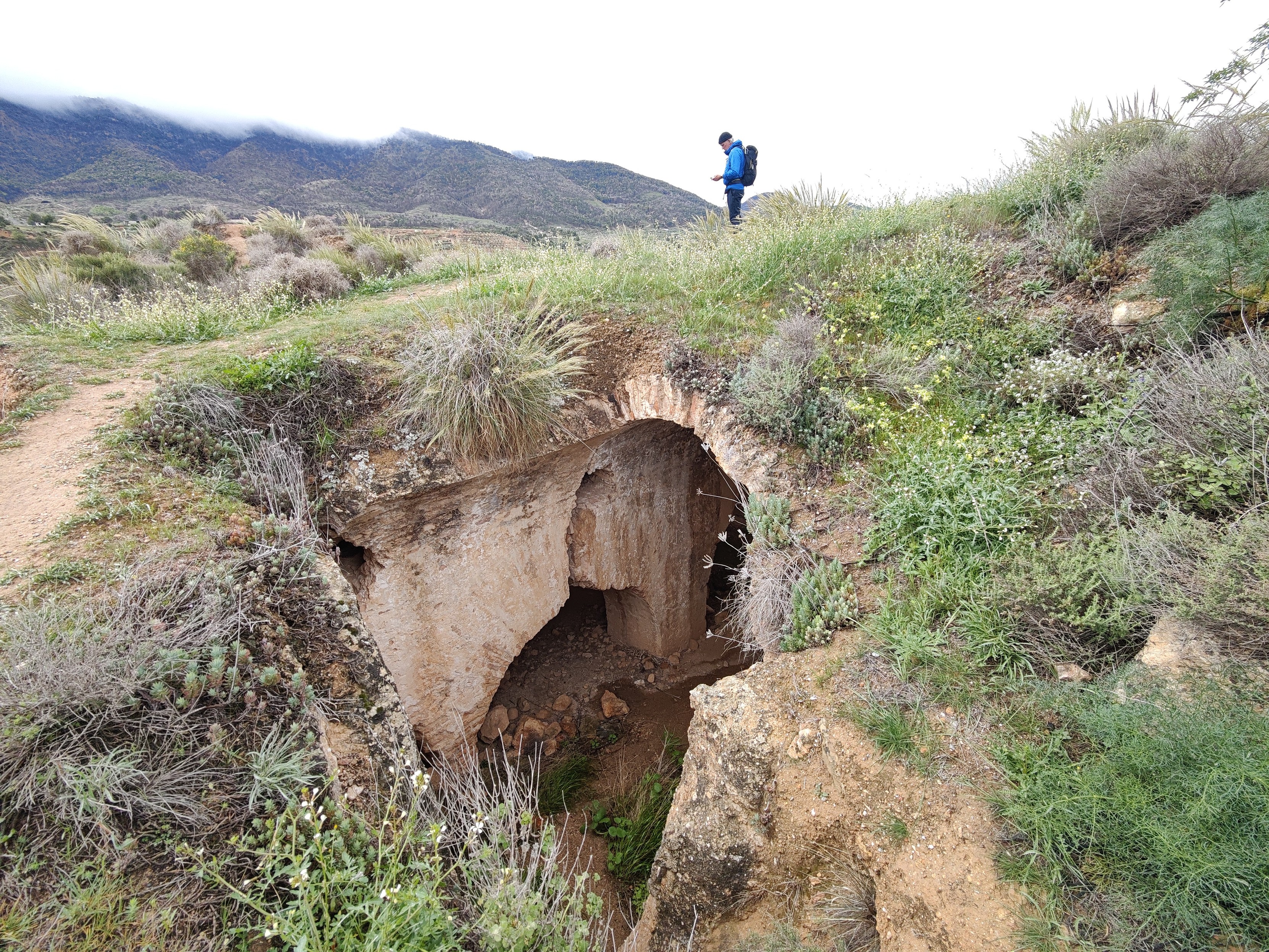 A man stands above some ancient arabic castle ruins