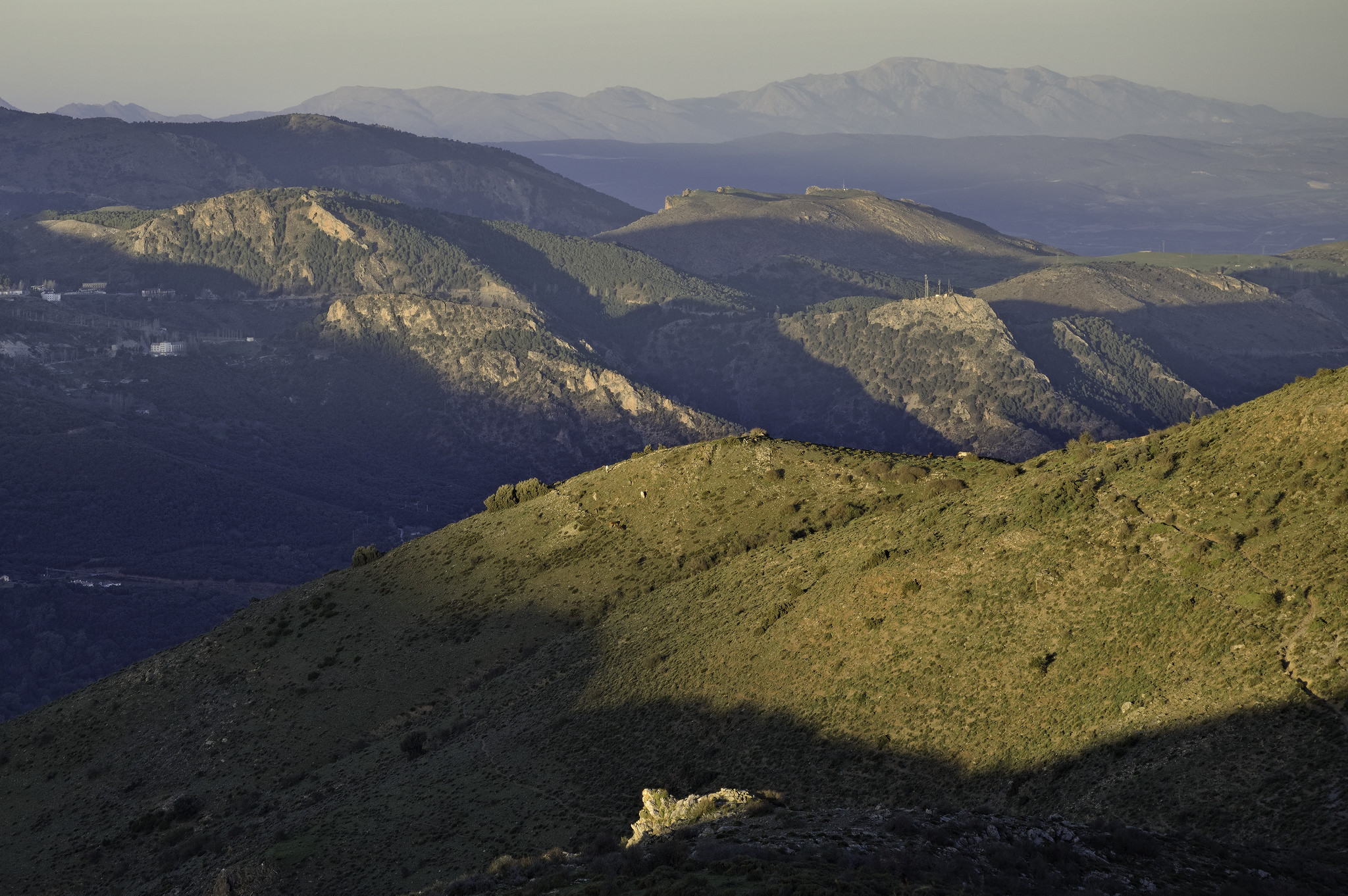 Lines of light illuminate the lower hills stretching to Granada