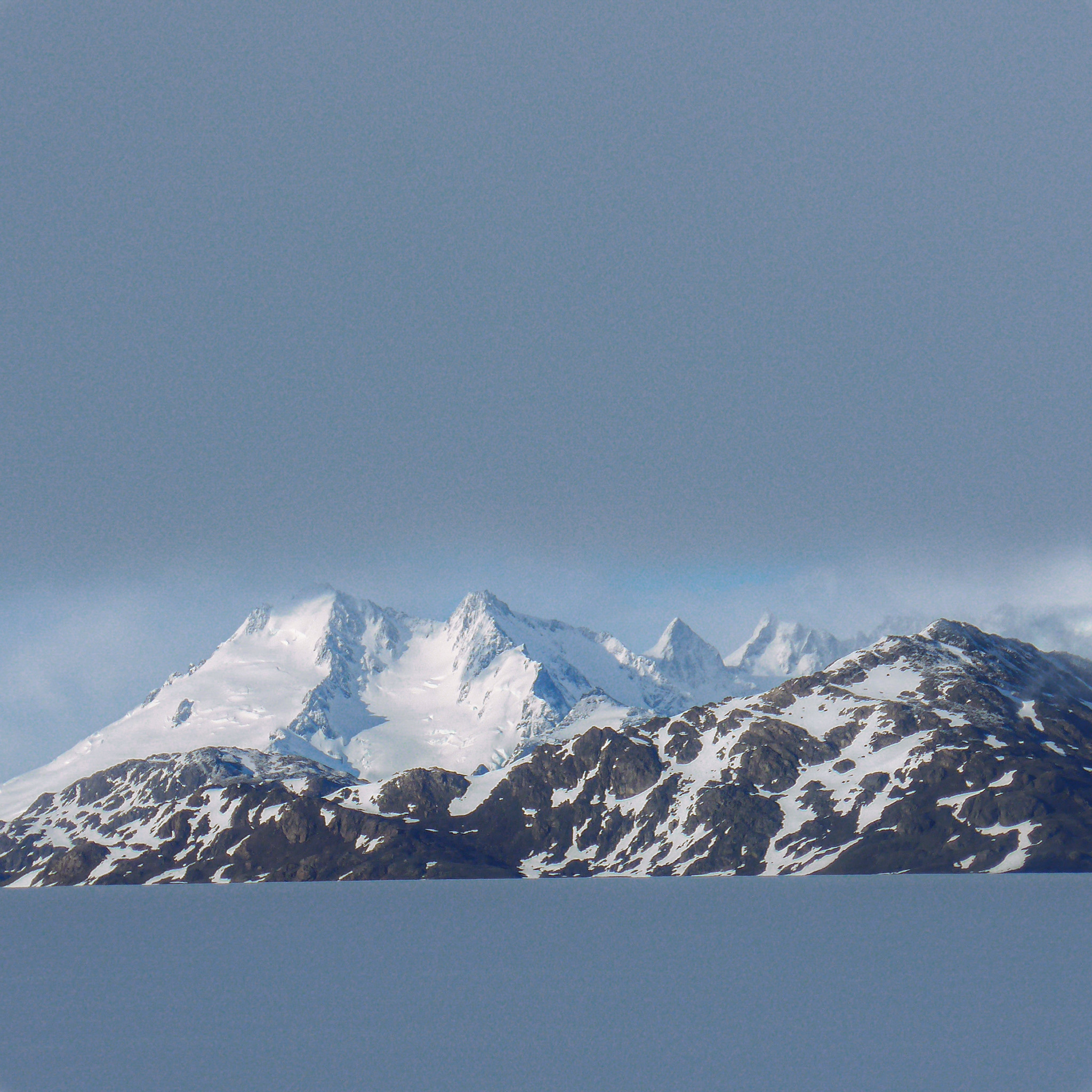Suddenly the mists lifted & out of the gloom a horizontal window appeared revealing some magnificent peaks.