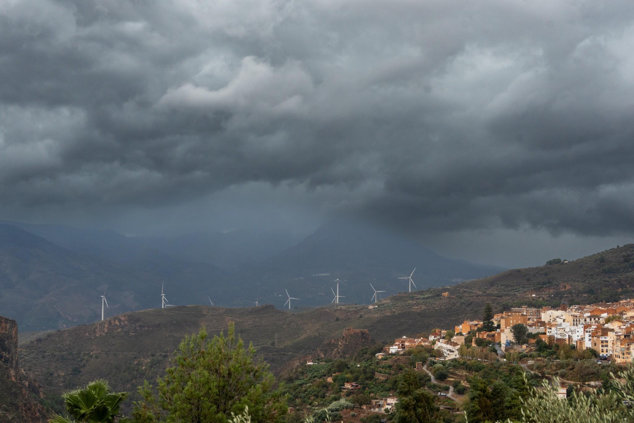 Some dark storm clouds lie above a spanish town