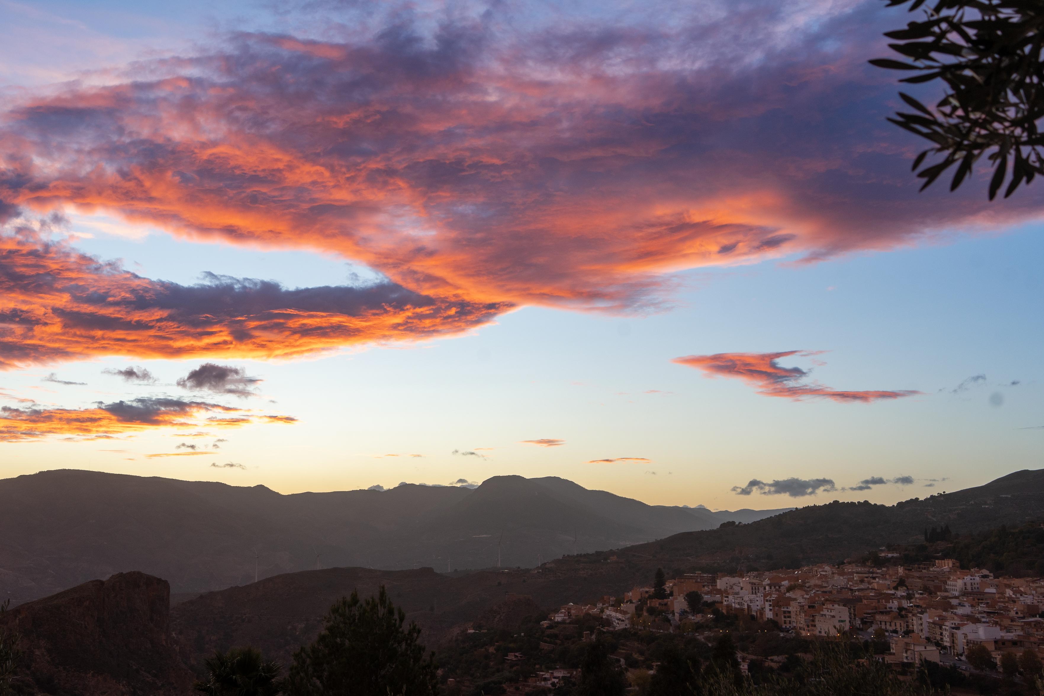 Some bright colored orange clouds above a spanish town