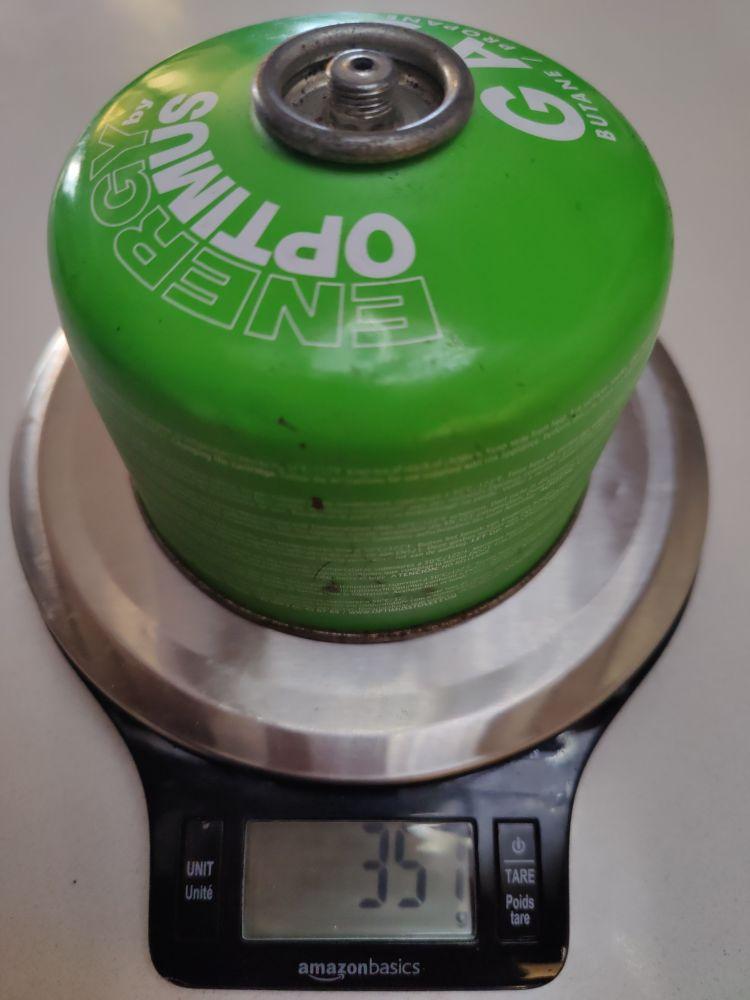 Weighing an old green gas cannister thats fiilled with recycled fuel