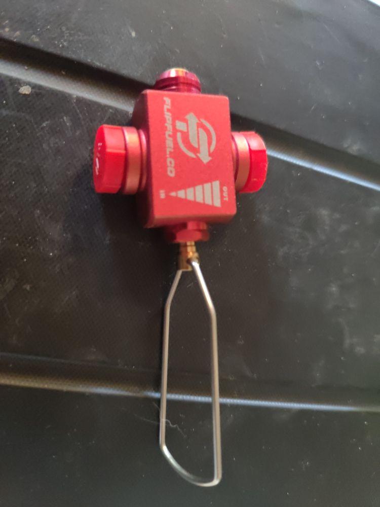 A red FlipFuel gadget that transfers gas between cannisters