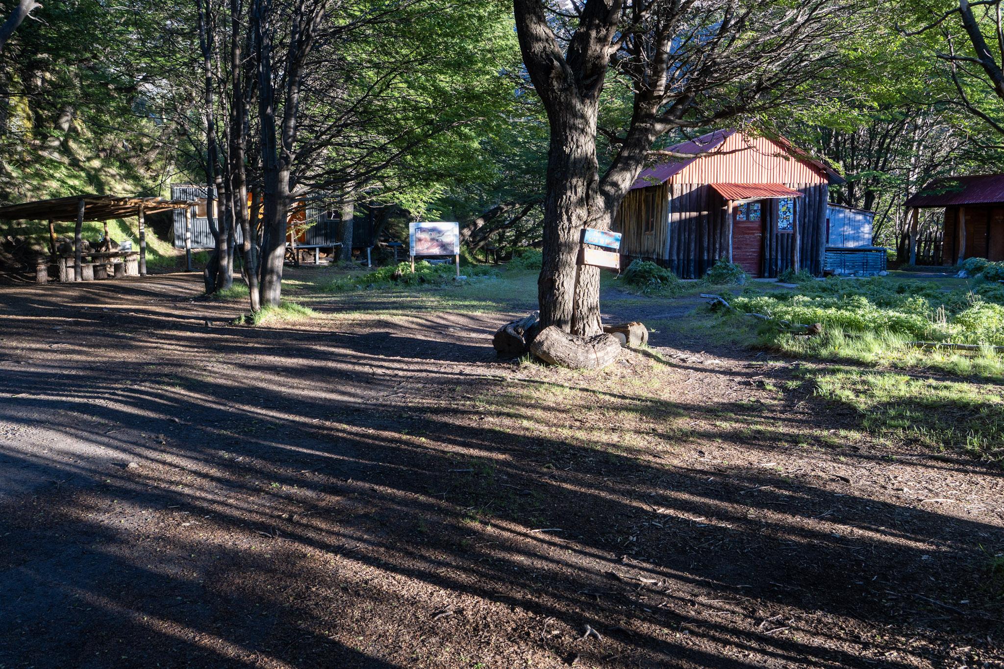 The cooking area, dormitory accommodation and toilet block sits amid a sheltered area of open woodland